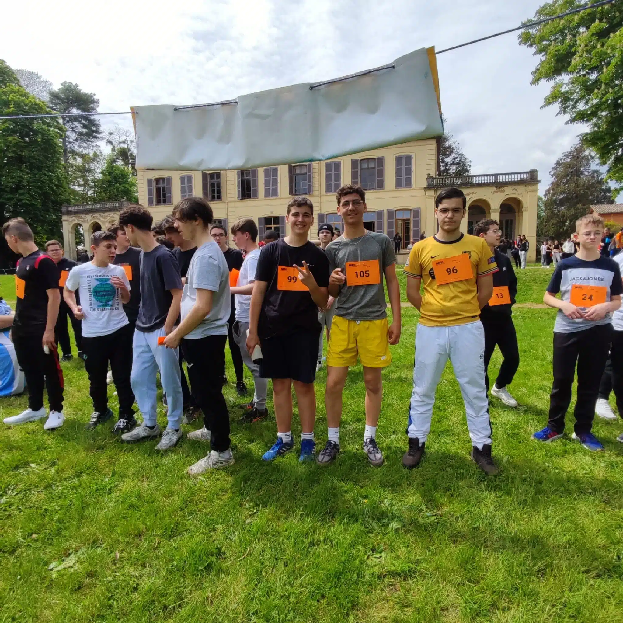 groupe de jeunes mfr devant un batiment jaune certains porte